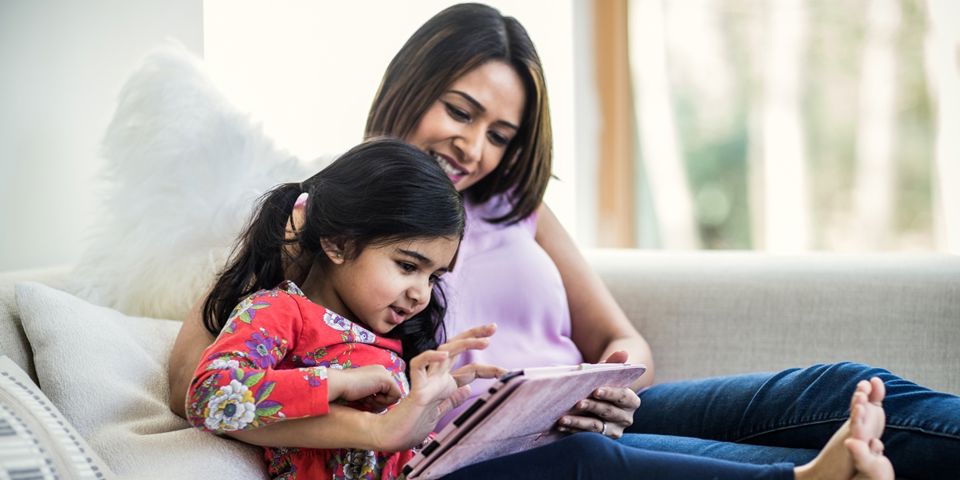 Mother with daughter on tablet
