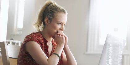 young woman looking at laptop