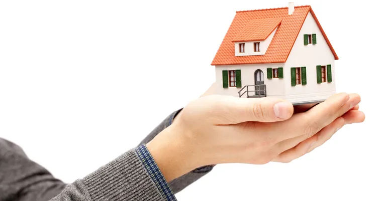hand holding house