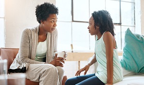 mother talking to daughter at home