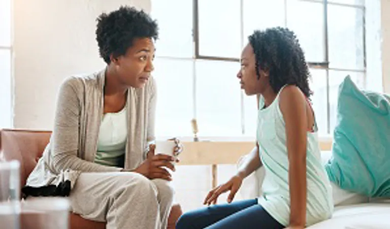 mother talking to daughter at home