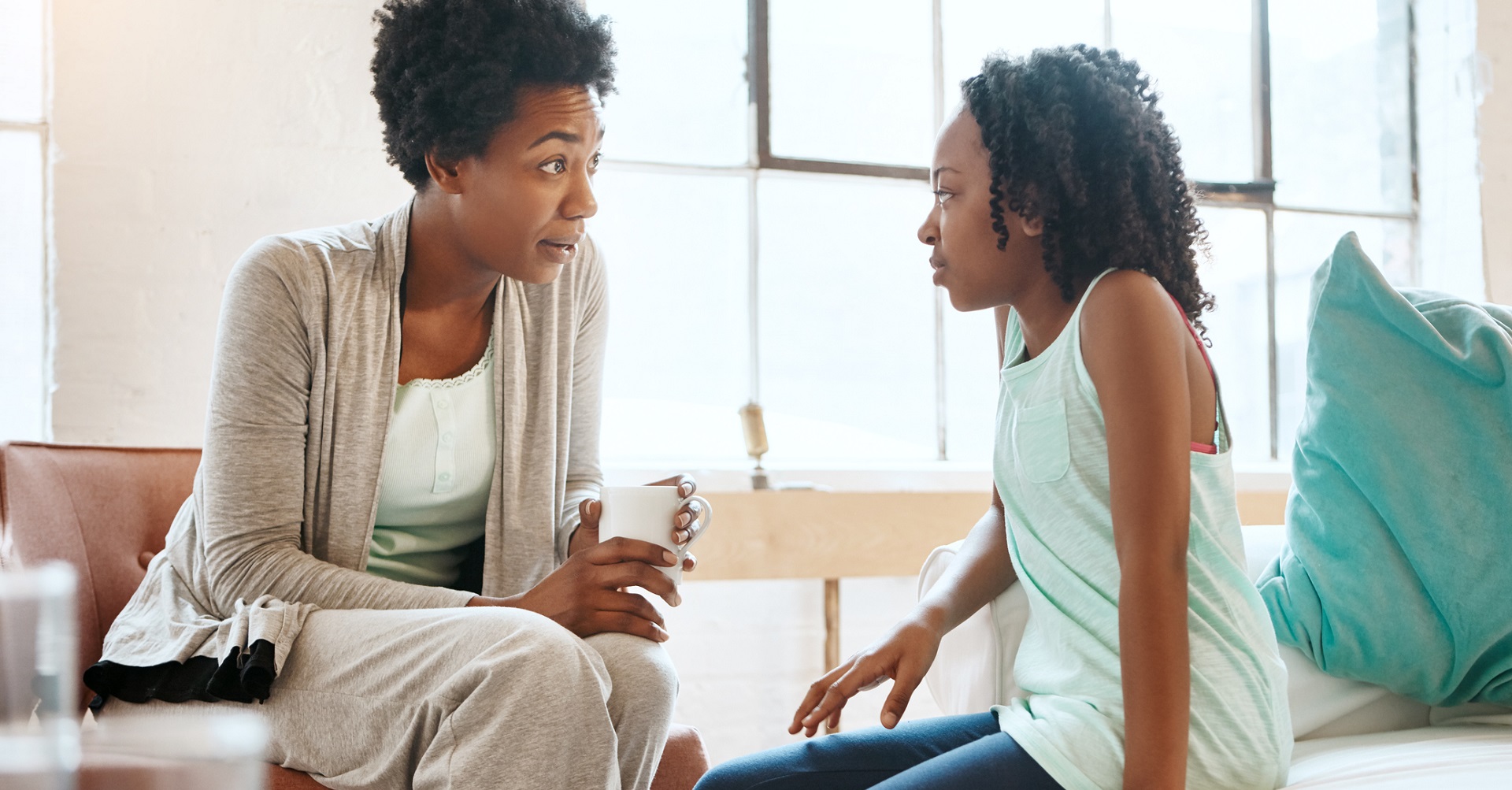 mother talking to daughter at home