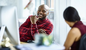 happy man sitting at desk