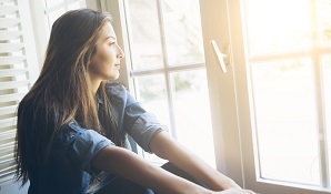 woman looking out the window