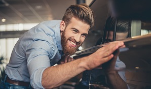 Man standing next to shiny new car