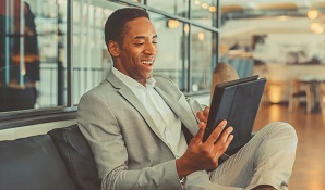 businessman on couch with tablet