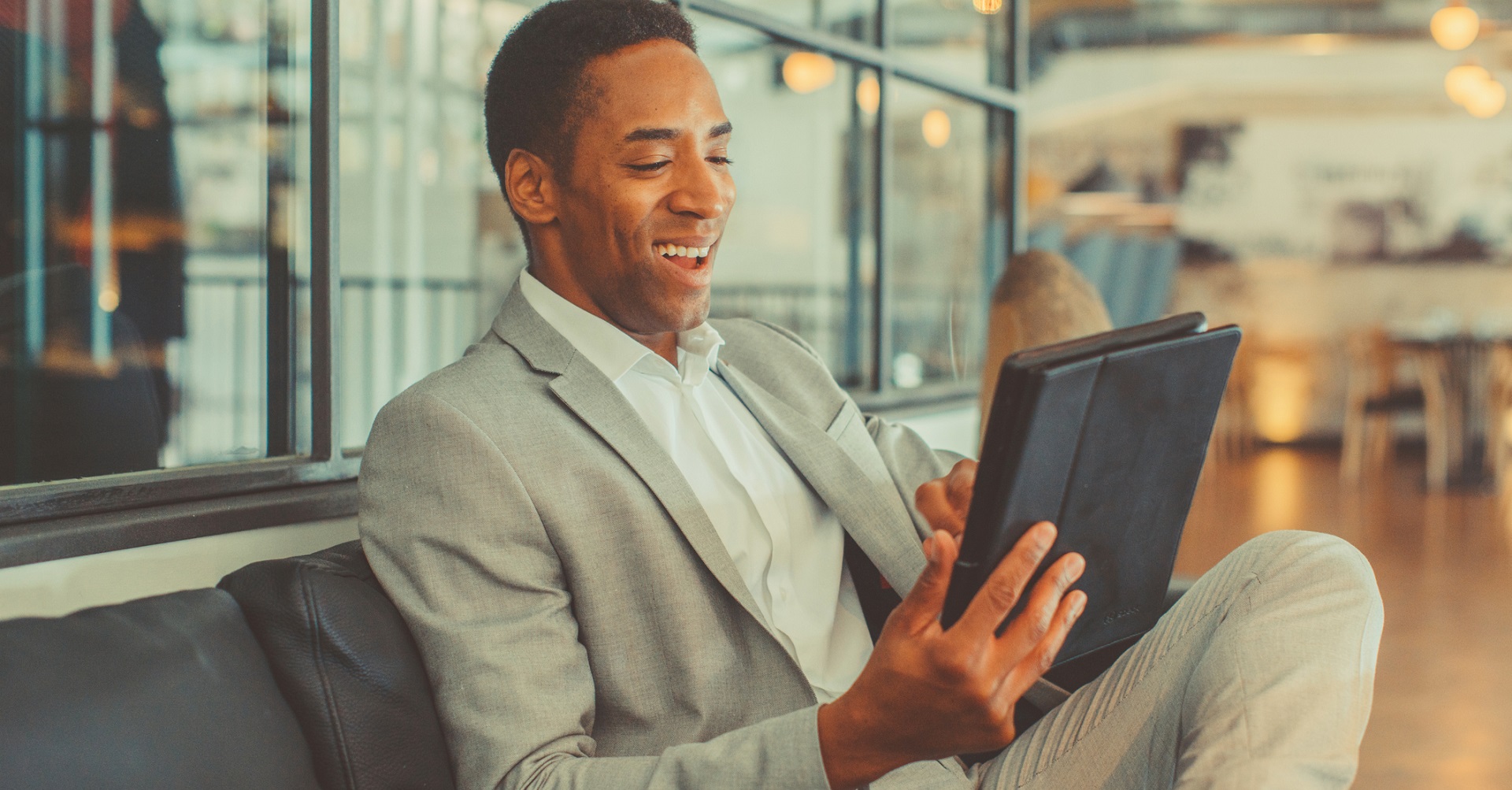 businessman on couch with tablet