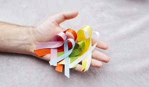 hand holding cancer ribbons