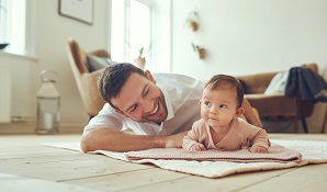 father and daughter cuddling on the floor