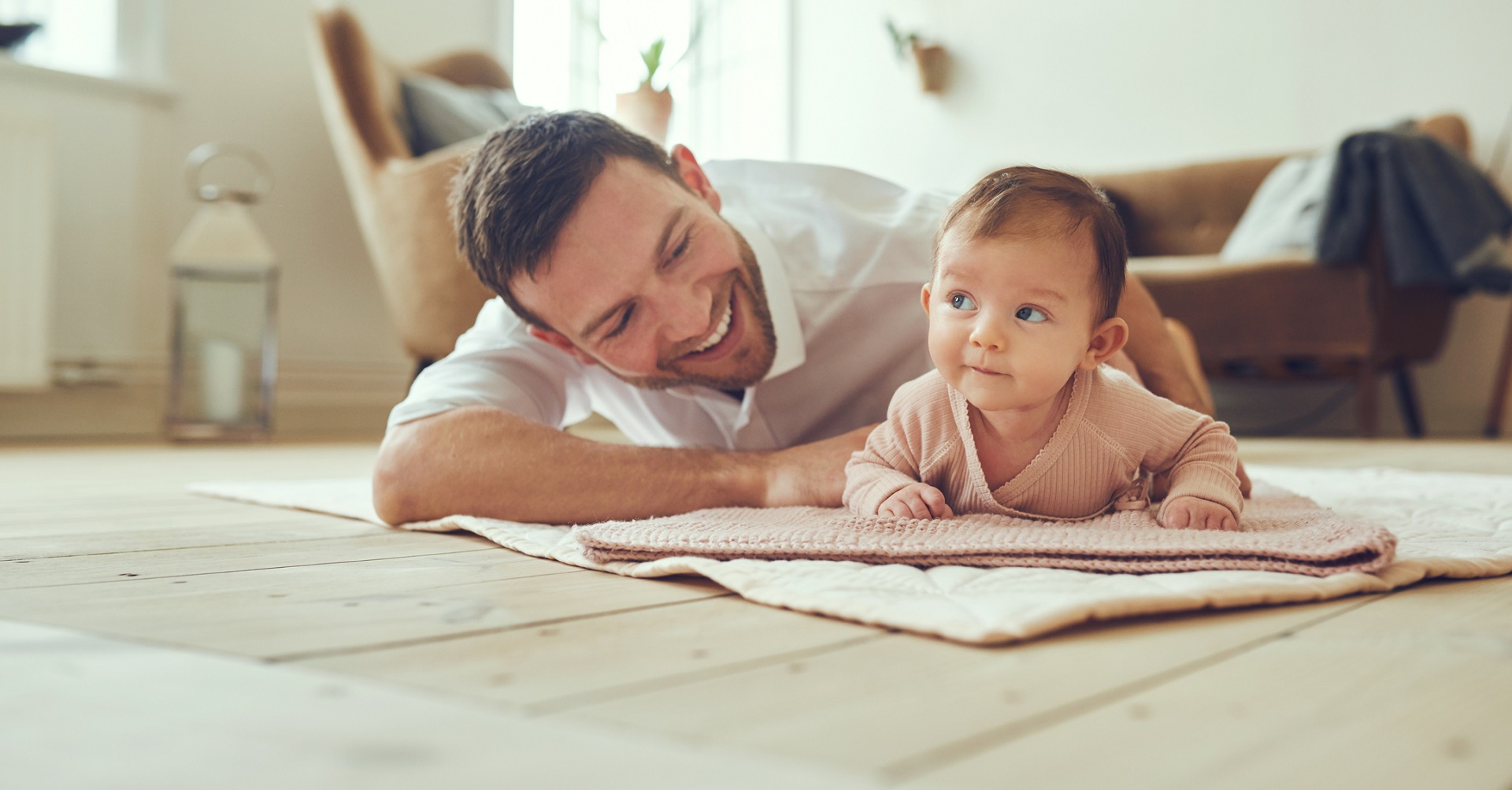 father and daughter cuddling on the floor