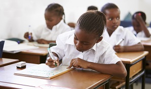 little girl sitting at school desk