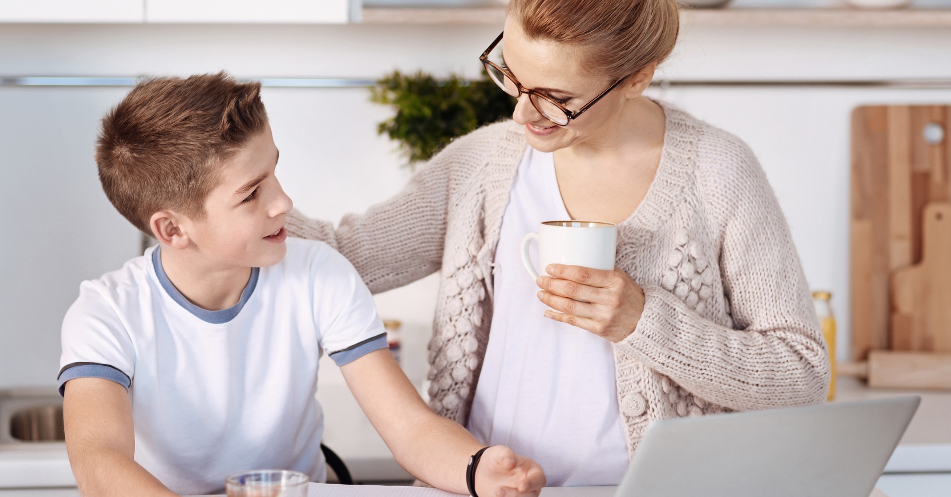 Little boy sitting at desk unhappy