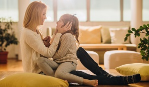 Mother sitting on the floor with child on her lap