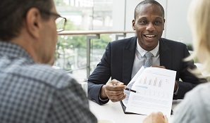 couple sitting and talking to financial planner