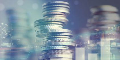 Pile of coins and financial charts
