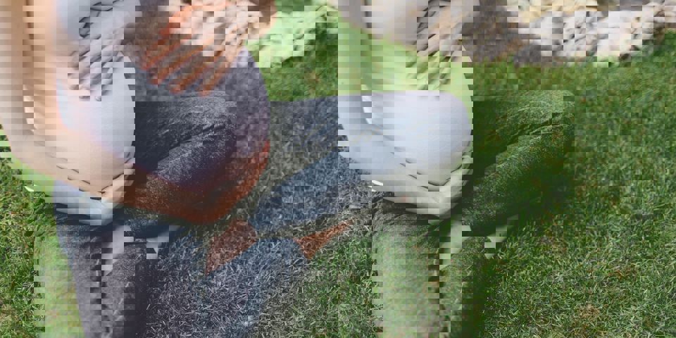 pregnant woman sitting on the grass