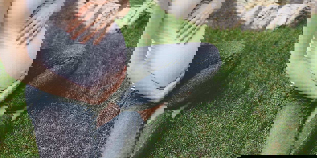 pregnant woman sitting on the grass