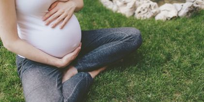pregnant woman sitting on the grass
