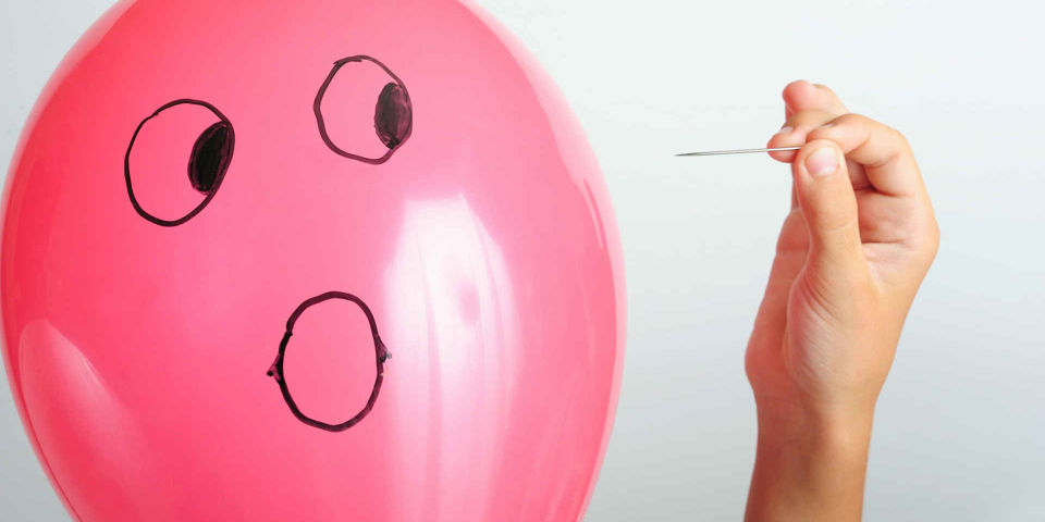 pin about to pop scared balloon