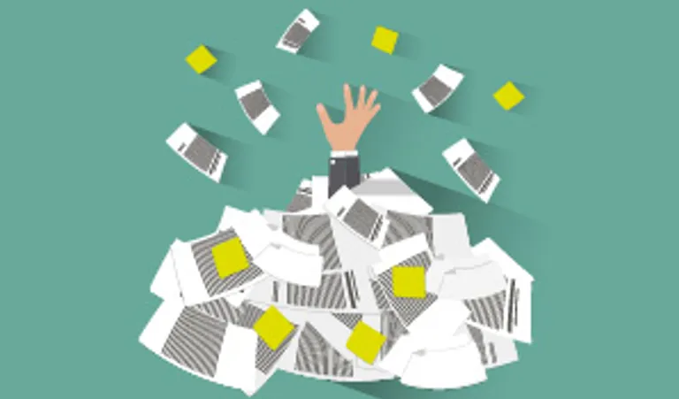 hand covered in paperwork