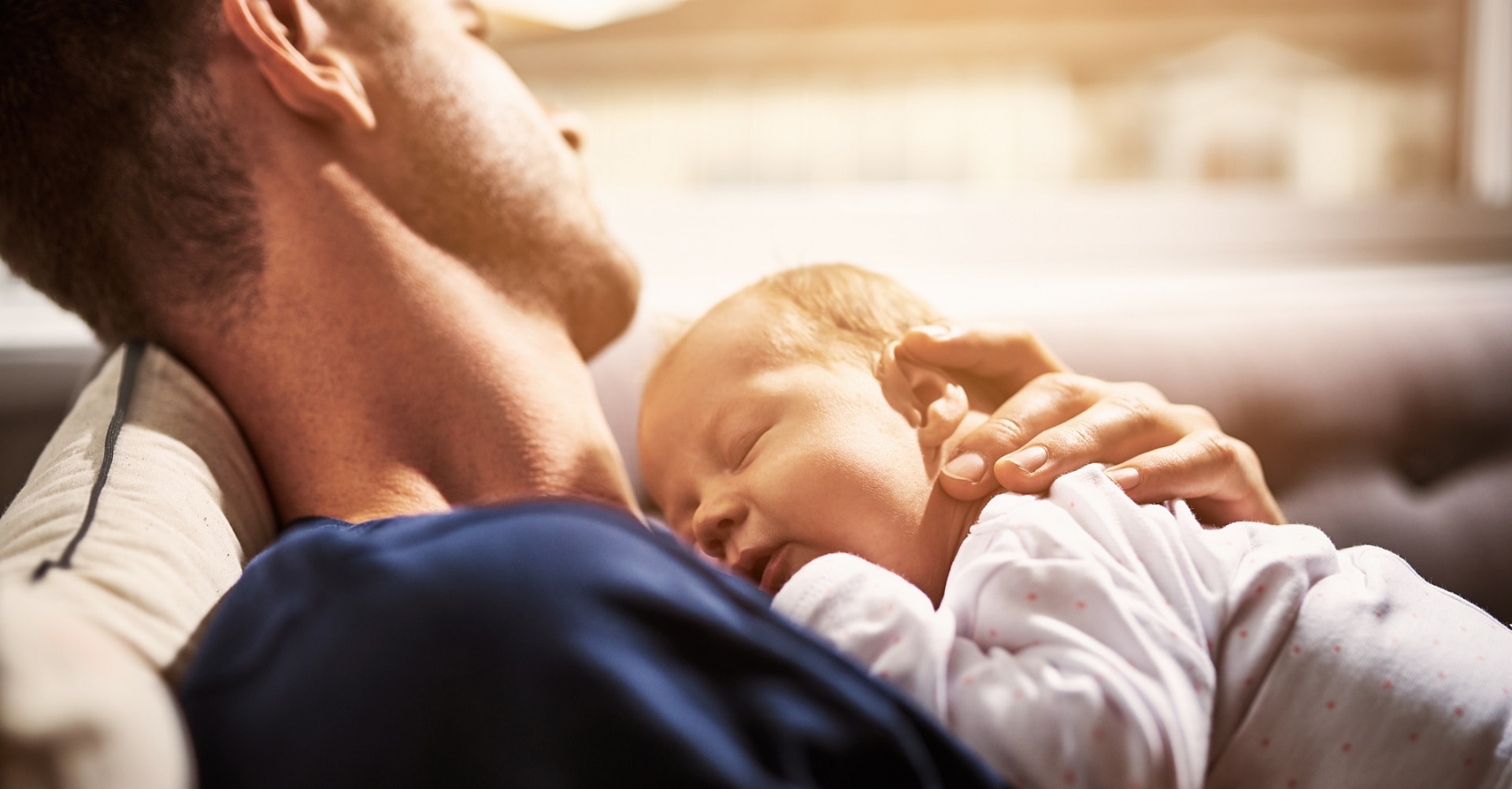 Father with baby laying on chest