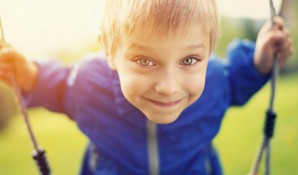 boy on swing in garden