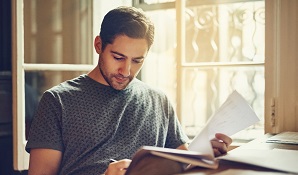 man sitting at desk with papers