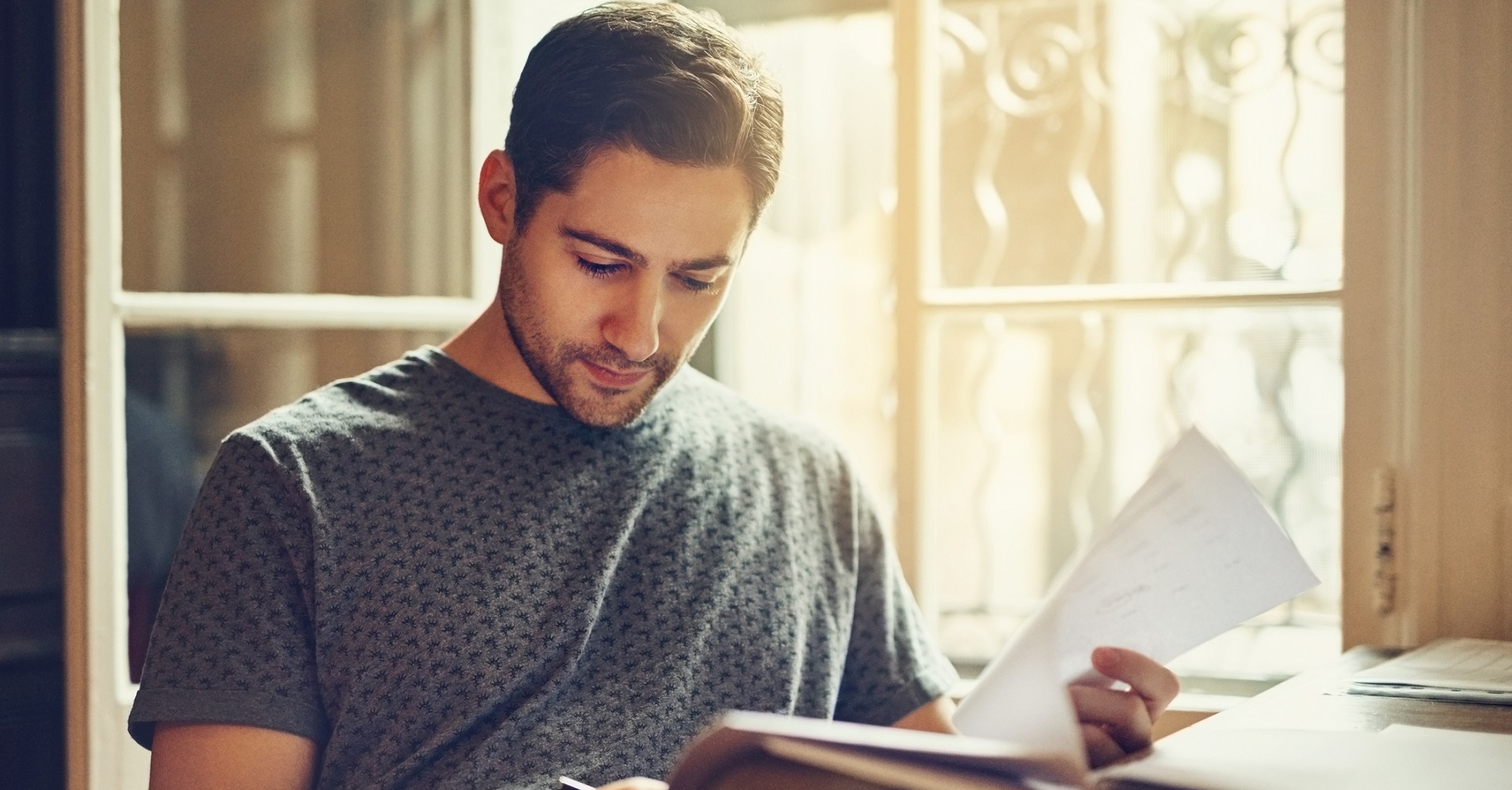 man sitting at desk with papers