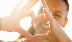 woman with heart sign hands