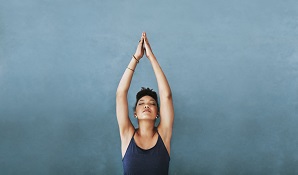 healthy woman standing with arms in air