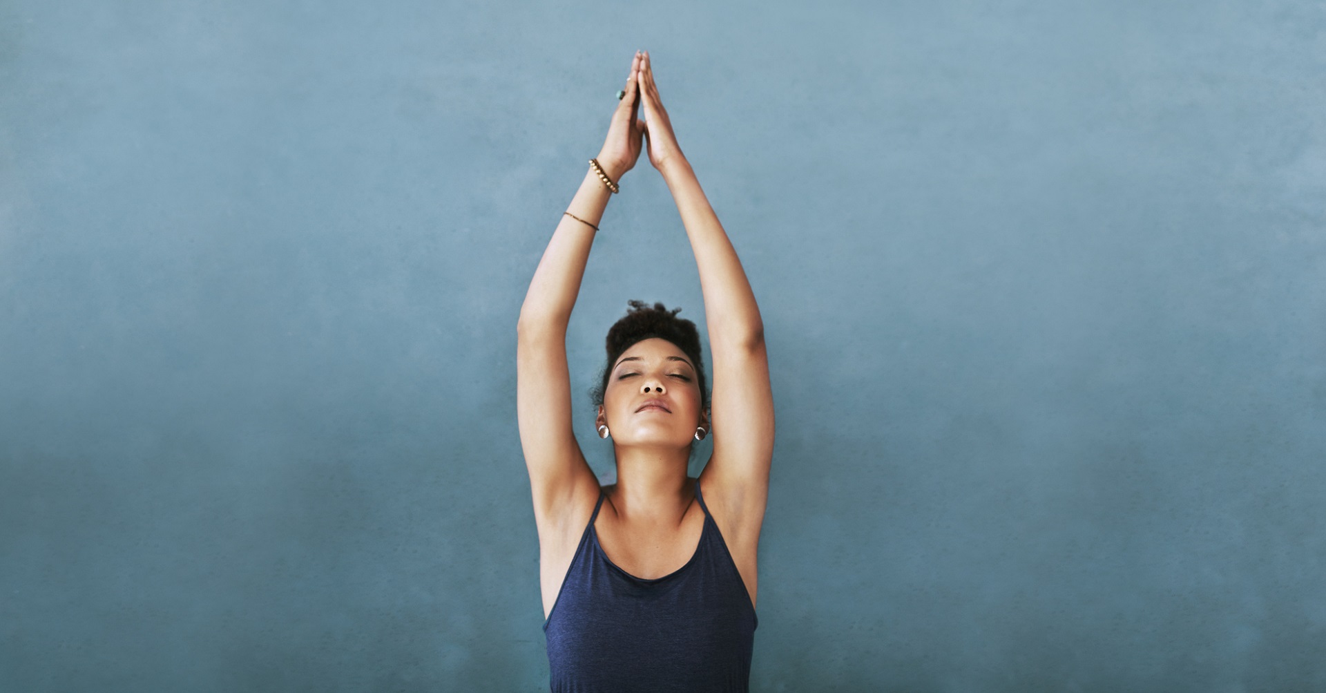 healthy woman standing with arms in air