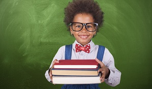 child with glasses holding school books