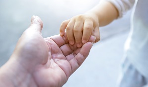 Mother holding child’s hand