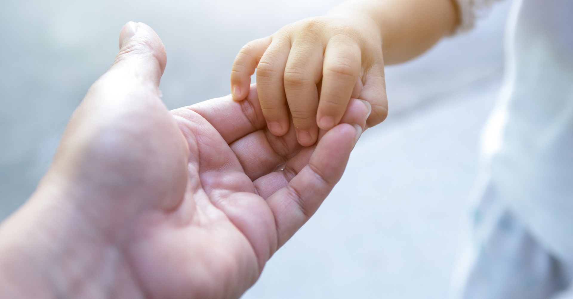 Mother holding child’s hand