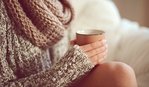 woman sitting with a cup of coffee