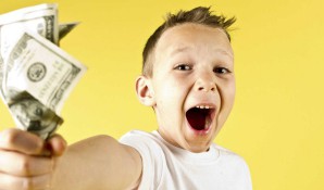 kid holding money with excitement on face