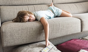 lazy child laying on couch