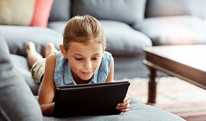 Little girl playing with a tablet