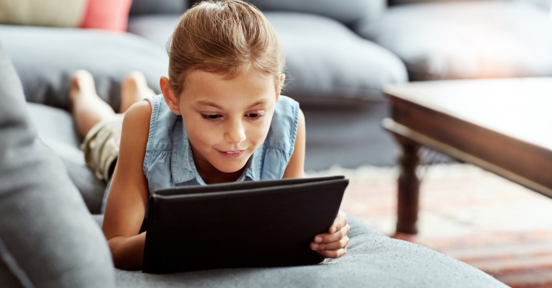 Little girl playing with a tablet