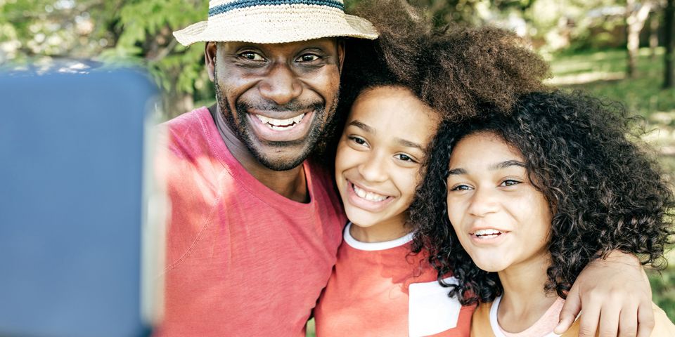 father taking selfie with kids