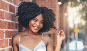 happy woman leaning against wall