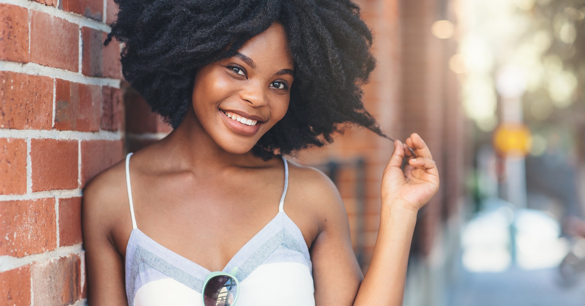 happy woman leaning against wall