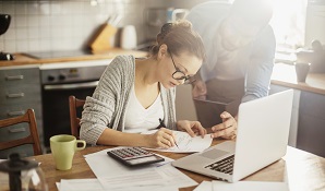 Woman doing paperwork with man next to her