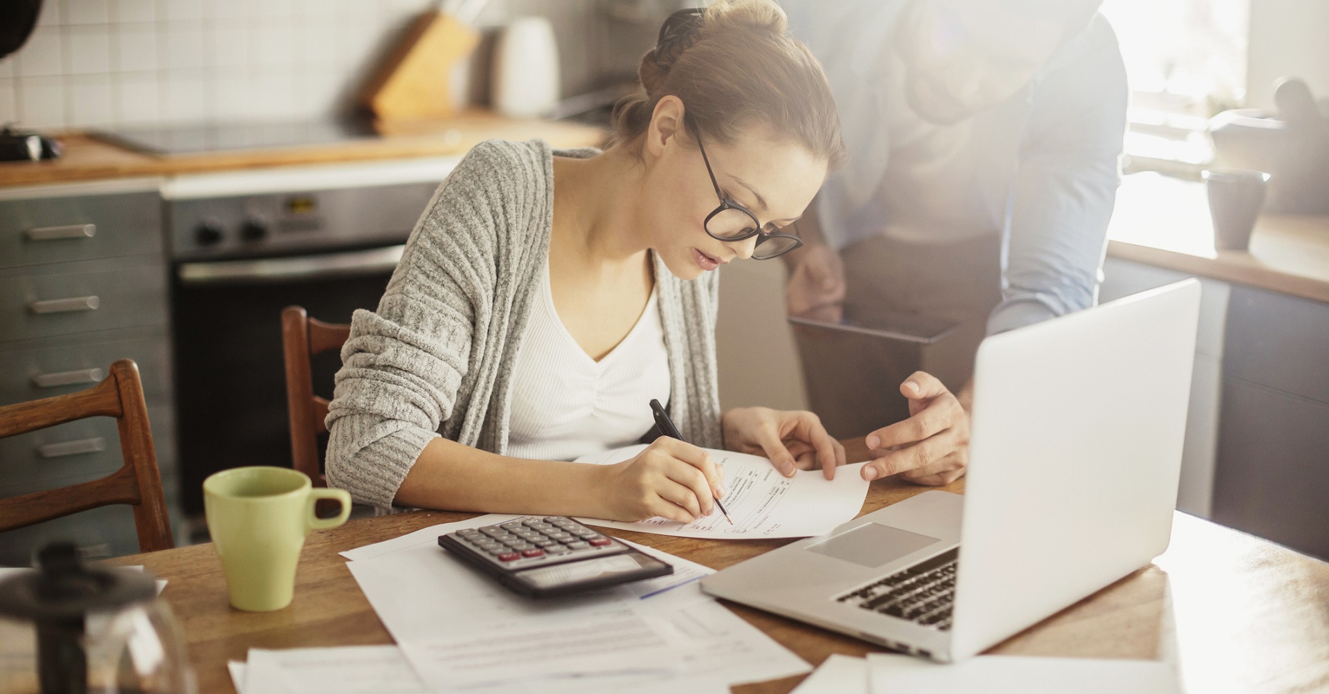 Woman doing paperwork with man next to her