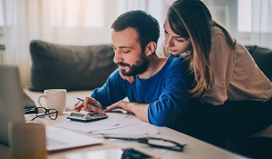 Couple sitting at desk working out finances