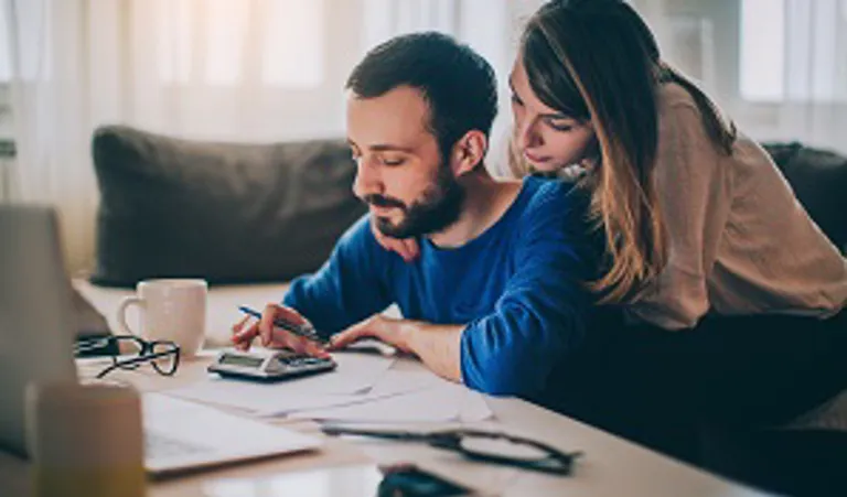 Couple sitting at desk working out finances