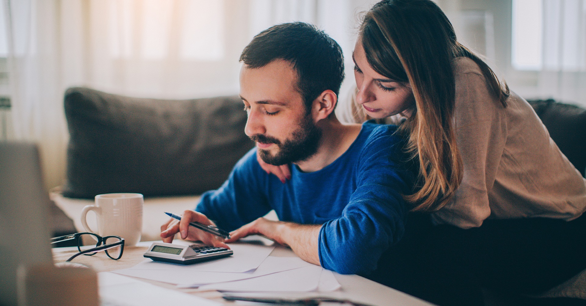 Couple sitting at desk working out finances