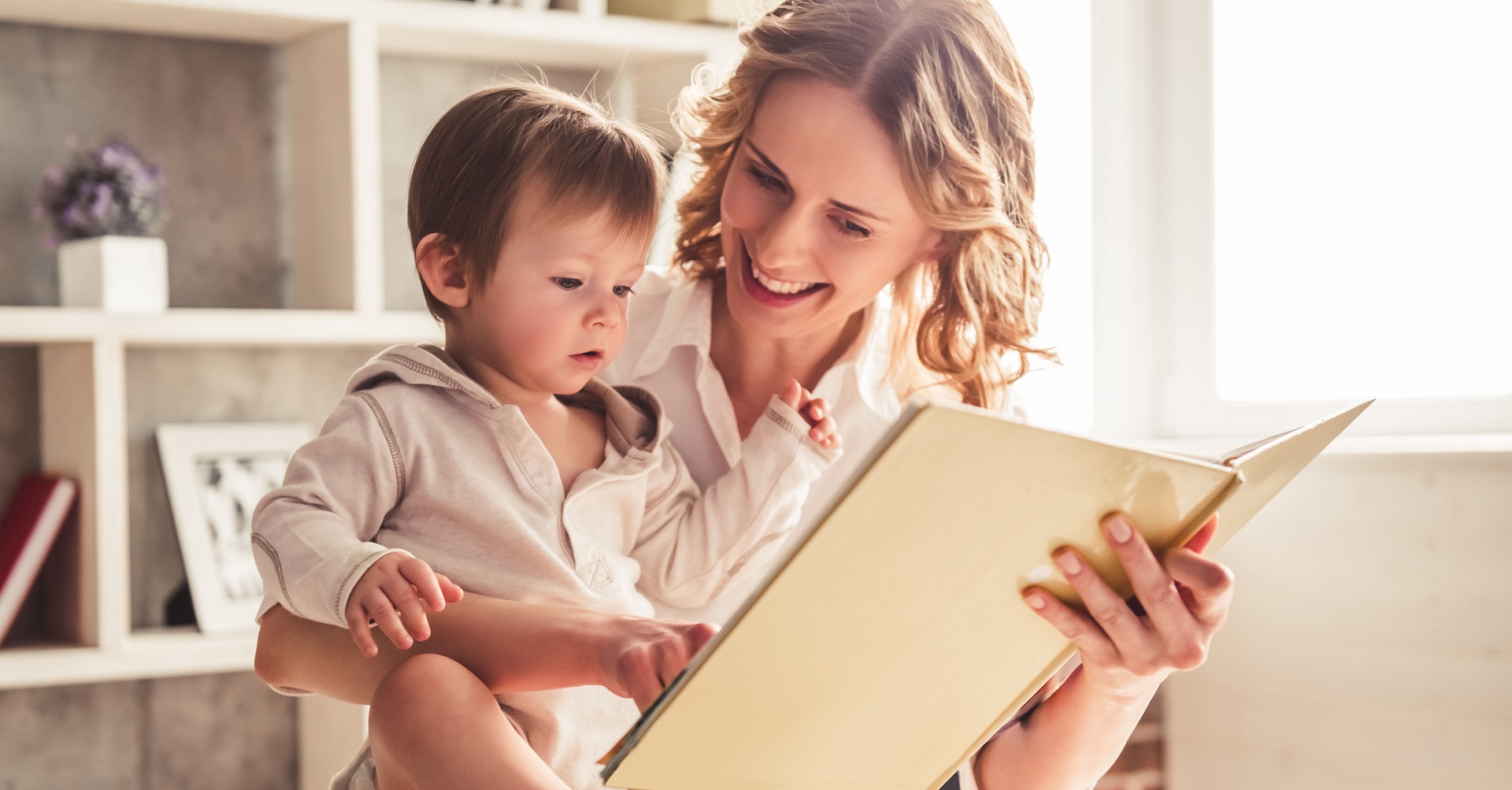 Woman on bed with daughter reading book