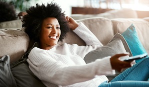 woman on couch watching TV