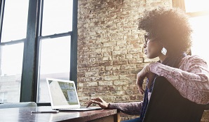 woman sitting at desk with a laptop 